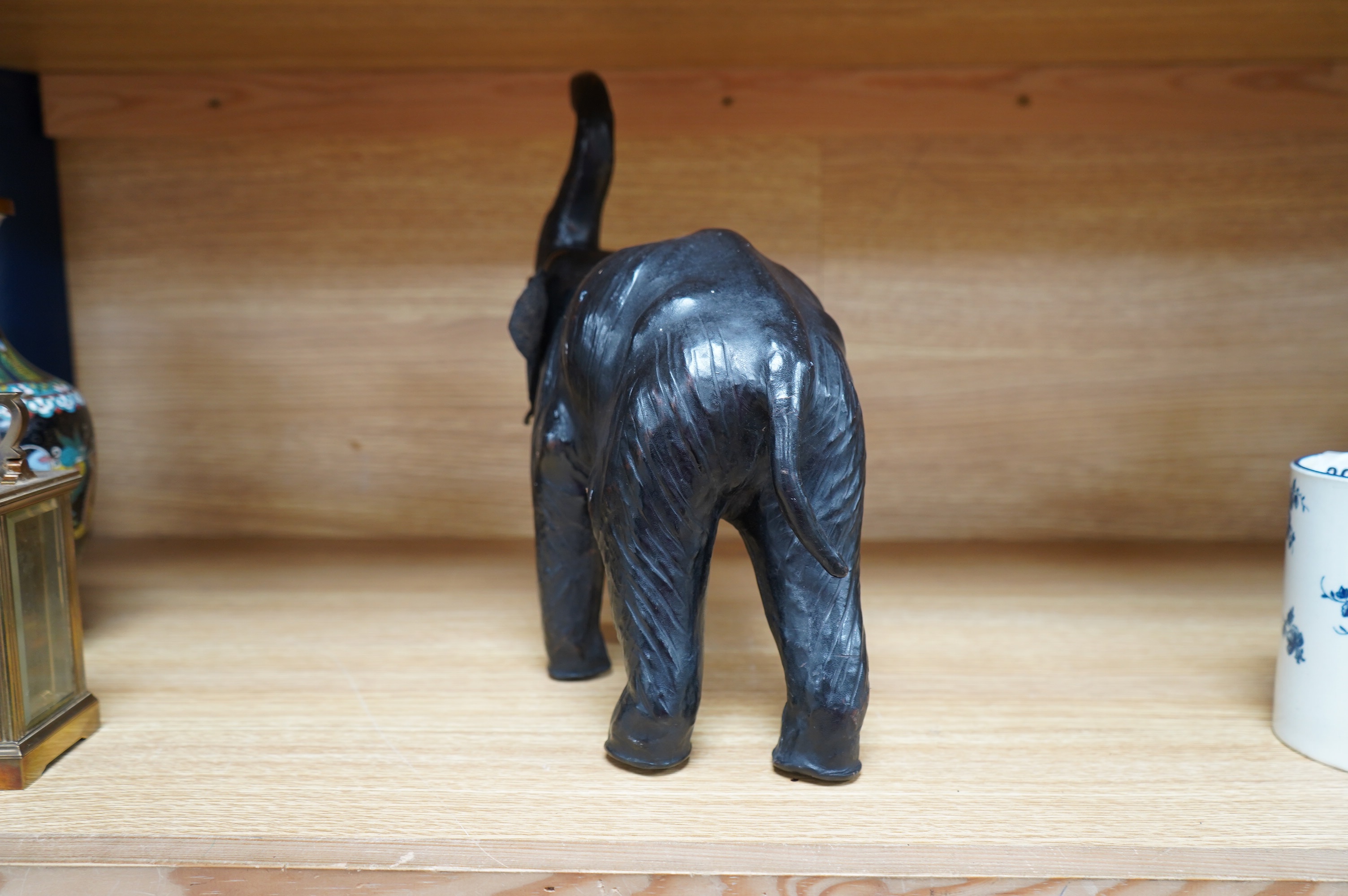 A small leather covered model of an elephant, stamped Liberty, 31cm. Condition - fair